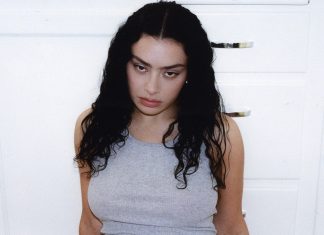 Charli XCX knows what your thirties feel like Charli XCX BRAT era wearing a grey vest